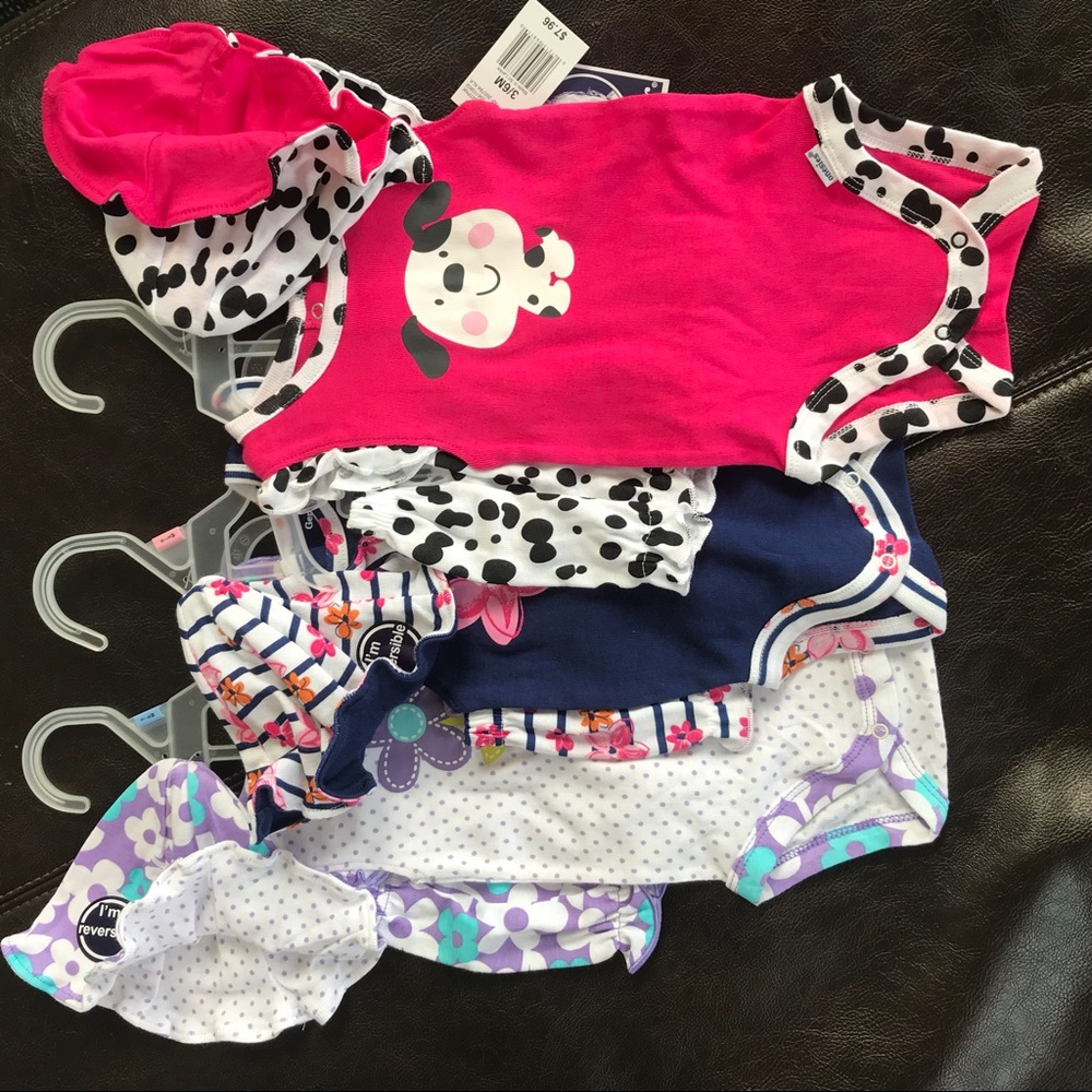 Lot of 3 Gerber baby girl outfit sets.